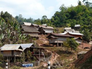 Typical village out in the countryside in Northern Laos. Many villages out here in the hills have no electricity or pipe-in water.