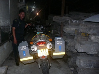 My bike Kuda, seen here locked up at the Tarakan customs warehouse along with confiscated timber logs.