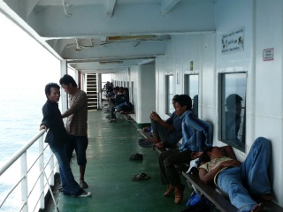 With seats and floor space inside taken up, the young men prefer to lounge outside