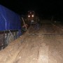 Beside the truck were workers working furiously all night to repair a Private bridge. In this weather condition, such private bridges are a money spinner.