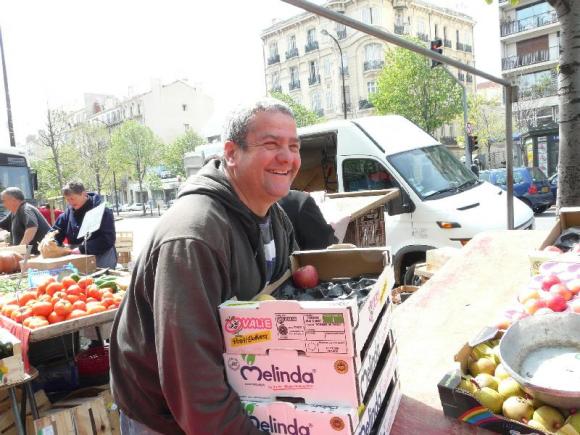 Happy fruit seller at Castellane street market, Marseille